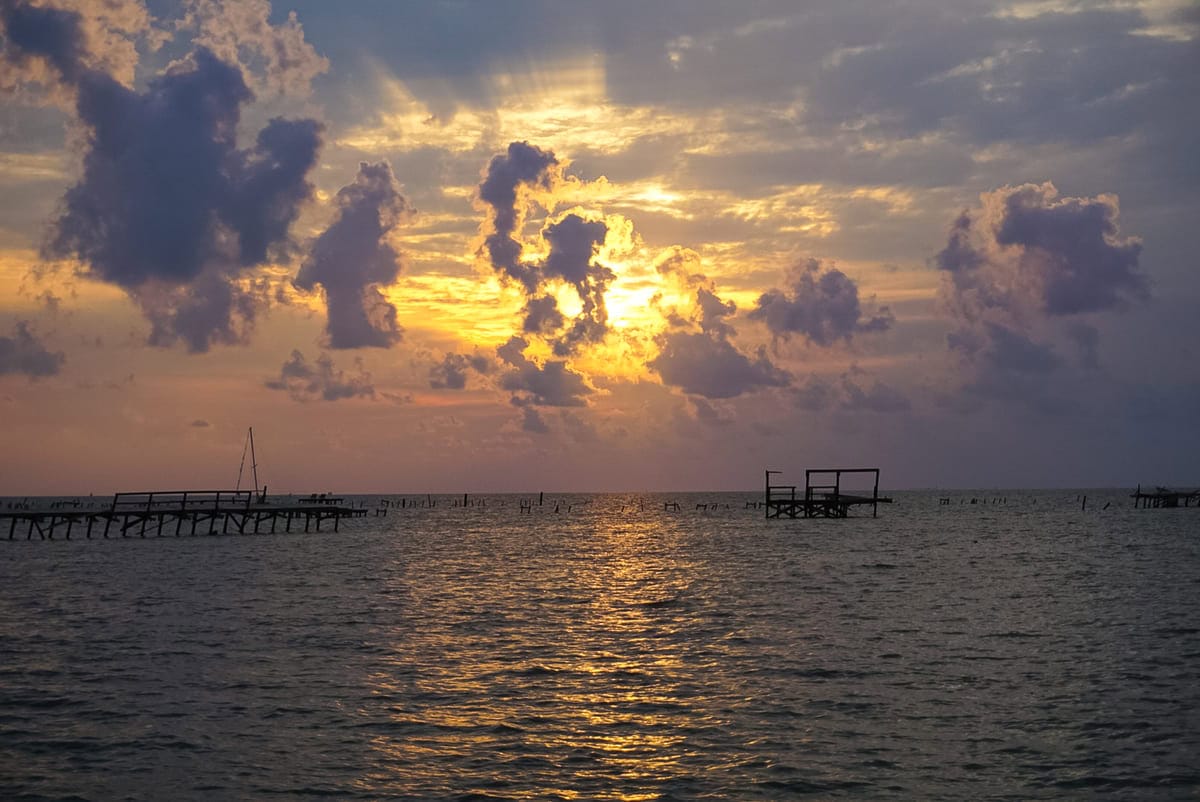 A Sunrise over the Bay with pier destruction in Rockport Texas.