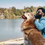 Man and his dog at a lake.