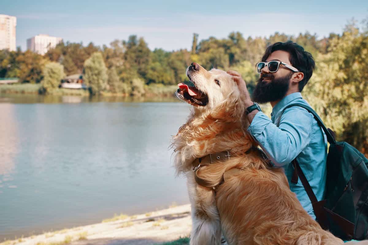 Man and his dog at a lake.